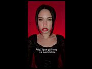 She stares bold with lips parted and chest bare
