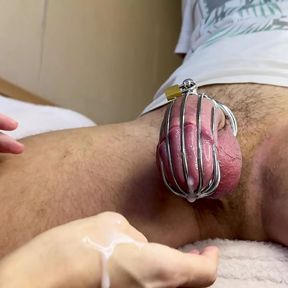 I stroke the head of his cock in a chastity belt. He sprayed me with cum