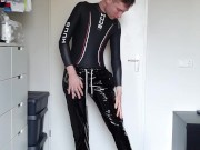 Boy putting on PVC over his wetsuit