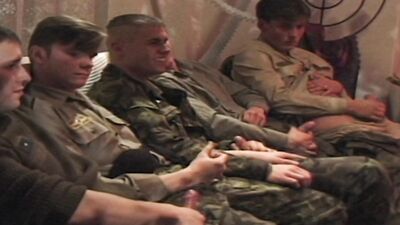 Slutty brunette pleases a bunch of soldiers at this sex orgy