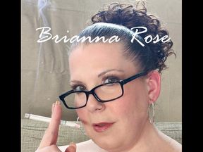 Kneeling on my chaise wearing a purple leopard print jumper, lacy stockings and shoes while smoking a VS 120