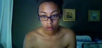 Ebony girl in glasses exposes her body for the webcam