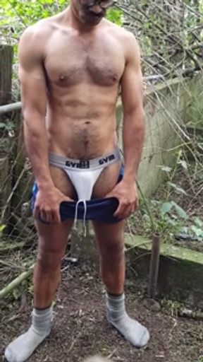 Dude in shorts and boots strips off and cums outdoors