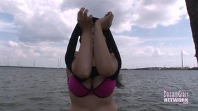 Huge tit brunette gets naked by the water