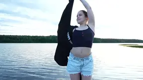 Two hot and flexible girls strip down by the lake.