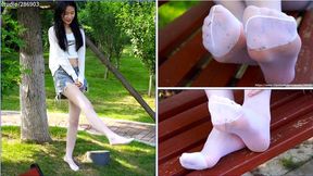 Dirty Feet - Girl in white stockings tramples the grass in the park with her bare feet