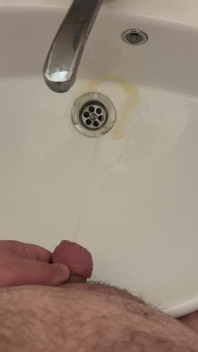 Fat man with a small dick pees in the sink