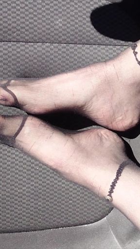 Feet of Nylonjunge in Pantyhose in Car