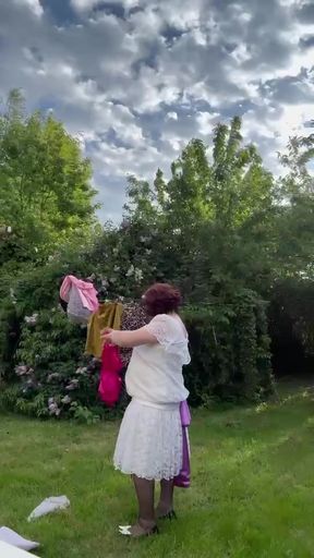 Dressed in a white lace dress to hang the laundry