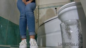 Filling a jar with her golden liquid and pipi accident in the bathroom