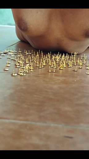 A Little Masochistic Submissive Lying on Thumbtacks