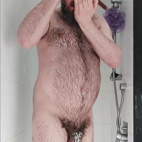 Hairy chastity bear showers and fingers his hole