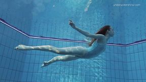 Red haired teen Anna Netrebko is undressing under the water