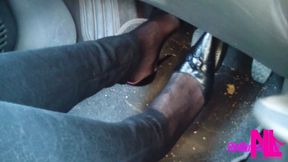 Driving and revving in black buckled pumps and jeans