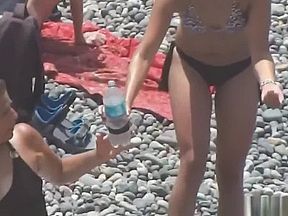 Very hot and tanned girls enjoying the beach and the sun