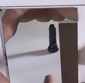playing a dildo in the mirror - back view
