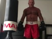 working the bag in red boxing trunks