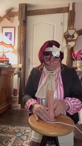 In an outfit with a little short skirt and a new blouse to suck a dildo at a party