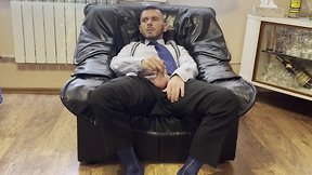 Businessman engages in suit fetish with sheer socks and pee-drinking