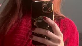 Sexy red sweater for a smoker in front of the mirror, dominatrix style