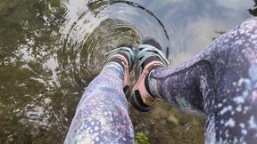 Fifi playing in the creek after yoga in leggings and socks with sandals