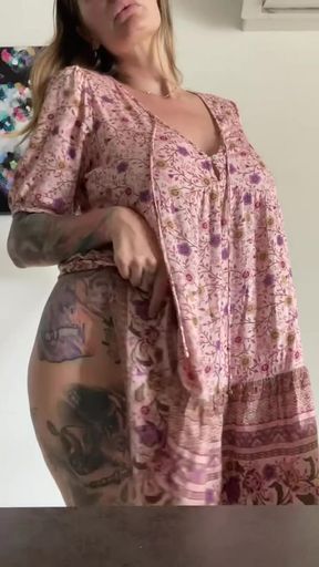 Tattooed woman in floral dress