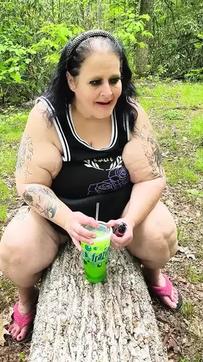 Sucking on a Straw in the Woods Squirting on Tree on Her Knees