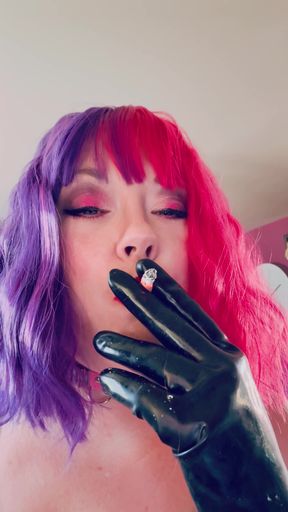 Key moment from &quot;Chubby Cougar Tina Snua Smokes A Cork Tipped Cigarette In Latex Gloves -&quot;