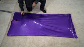 A girl experiences an orgasm in a lilac vacuum bed with an inflatable gag in her mouth