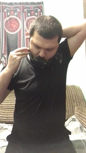 A man puts a gag in his mouth and an anal plug