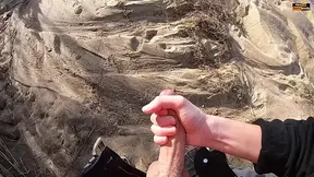 Risky public beach handjob turns into a messy load shot