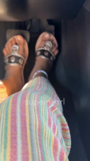Driving with natural toes in gold sandals