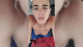 Androgynous teen with blue eyes uses vibrator on her bush