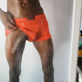 Tall sexy African man with a very big black cock rubs his cock in  front of a mirror home alone