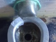 Taking a leak in a nasty outdoor public bathroom