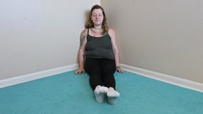 Rhea peels off her work socks to show her feet (720)