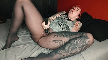 Lusty horny tattooed bitch in pantyhose fucks her wet pussy with a vibrator and squirts in all directions