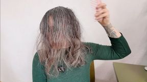 she is brushing her natural wet hair aV