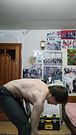 A hot fitness instructor does a home workout and poses with a sexy body