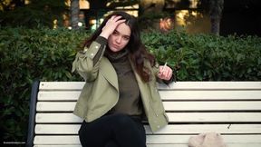 Young Brunette Is Taking an Unhurried Stroll with Allwhite 120mm Cigarette