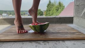 beautiful feet crushed a watermelon