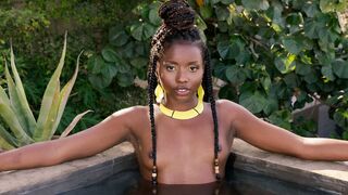 Flexible ebony posing naked in the pool