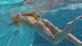 Latvian femme fatale flaunts her assets by the poolside hot tub.