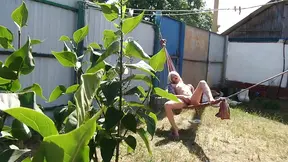 Outdoor solo euro blonde jerks off in a hammock