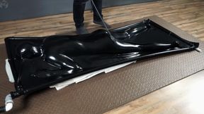 Spanking in a black latex vacuum bed
