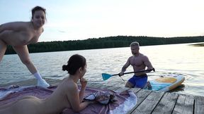 two girls took their clothes off on the lake. a passing surfer had sex in the open air.