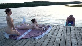 two girls took their clothes off on the lake. a passing surfer had sex in the open air.