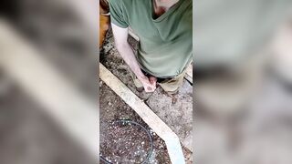 A sporty stud in a military uniform strokes off and ejaculates outdoors