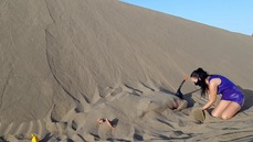 Latex mistress buries slave under sand in desert