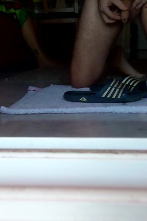 John is peeing on the bathing slippers on the floor